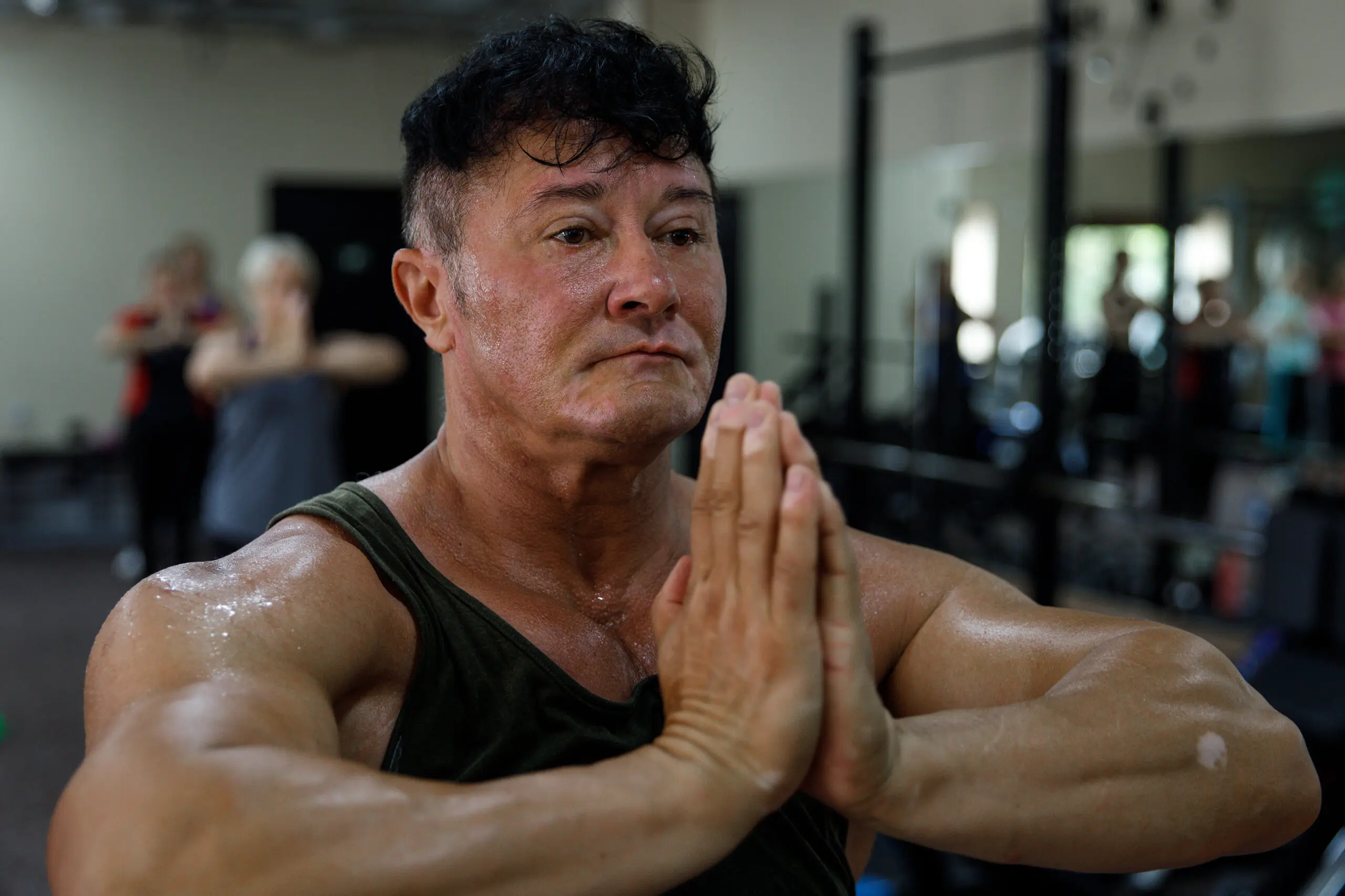 Anna Kurkurina brings her hands to prayer in a group fitness class.