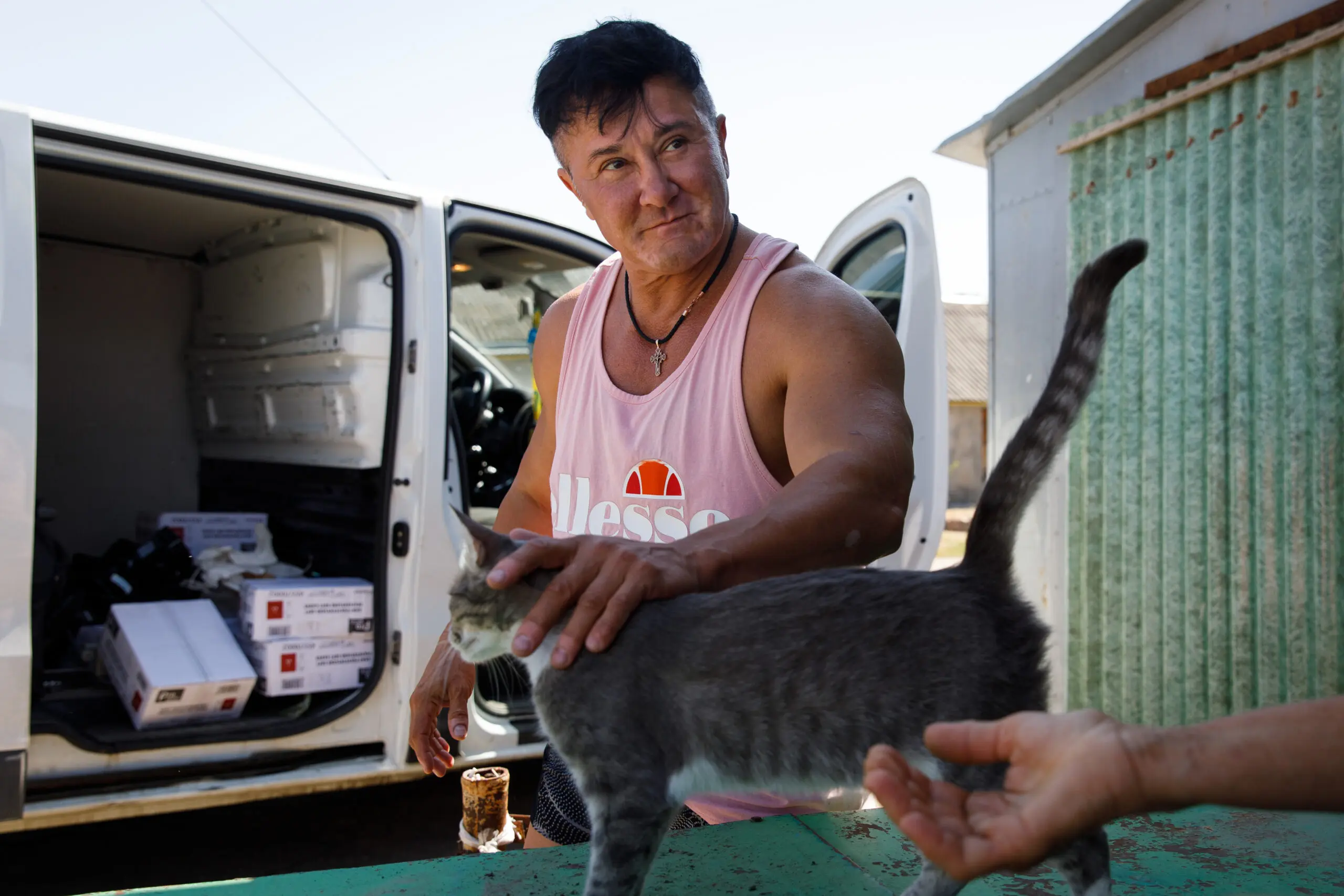 Kurkurina pets a cat during a visit to a village in the Kherson region.